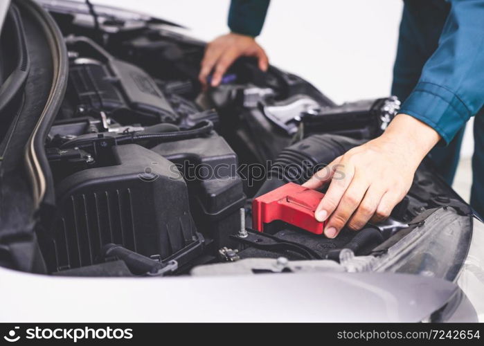 Professional mechanic hand providing car repair and maintenance service in auto garage. Car service business concept.