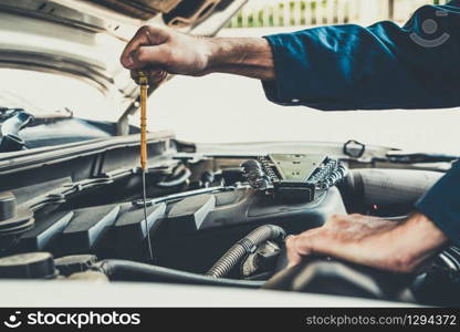 Professional mechanic providing car repair and maintenance service in auto garage. Car service business concept.