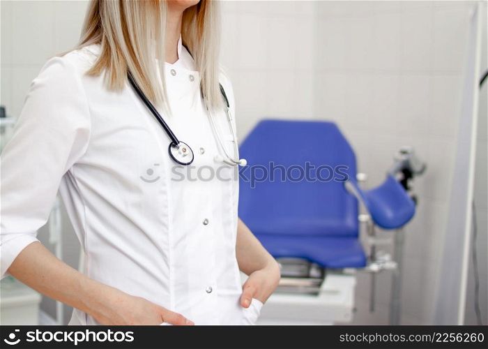 Professional medical physician gynecologist doctor in white uniform in clinic hospital. Gynecological cabinet with chair and other medical equipment on background. Woman health and pregnancy concept. Professional medical physician gynecologist doctor in white uniform in clinic hospital. Gynecological cabinet with chair and other medical equipment on background. Woman health and pregnancy concept.