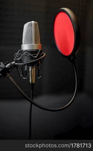 Professional microphone closeup, recording studio equipment, nobody. Audio, sound and music record in best quality. Professional microphone closeup, recording studio