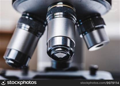professional microscope in laboratory, science equipment and medical tools to looking micro scale, microbiology and medicine research in laboratory with microscope