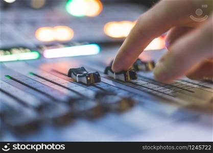 Professional music production in a sound recording studio. Sound engineer is working.