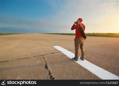Professional photographer taking photo on road. Element of design.