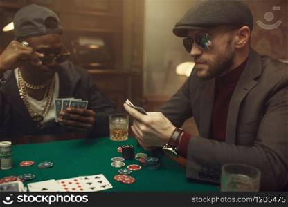 Professional poker player feels the risk, casino. Games of chance addiction. Man with cards in hands leisures in gambling house. Professional poker player feels the risk, casino