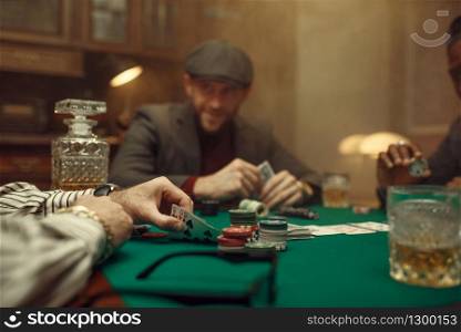 Professional poker player playing in casino. Games of chance addiction. Man with cards in hands leisures in gambling house. Professional poker player playing in casino