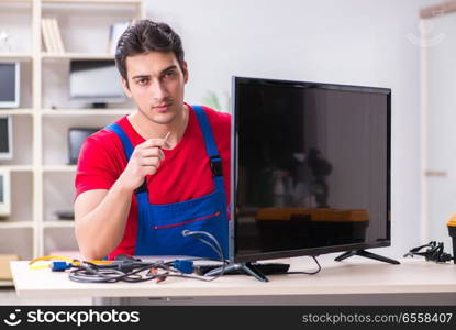 Professional repair engineer repairing broken tv