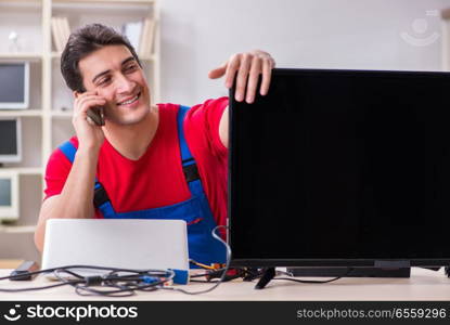 Professional repair engineer repairing broken tv