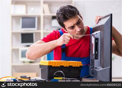 Professional repair engineer repairing broken tv