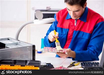 Professional repairman repairing computer in workshop