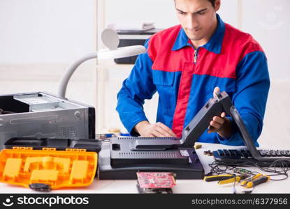 Professional repairman repairing computer in workshop