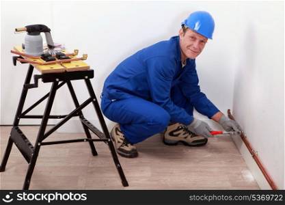 professional repairman working on a wall