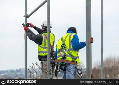 Professional Scaffolders erecting scaffolding on a building in the UK