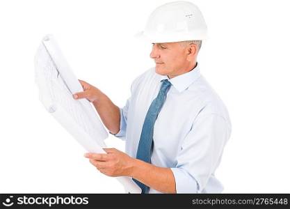 Professional senior architect with protective helmet looking at blueprints
