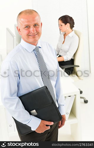 Professional senior businessman hold briefcase in office with attractive secretary