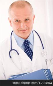 Professional senior doctor male with stethoscope portrait with document folders