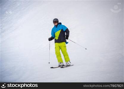 Professional skier riding the downhill on ski resort