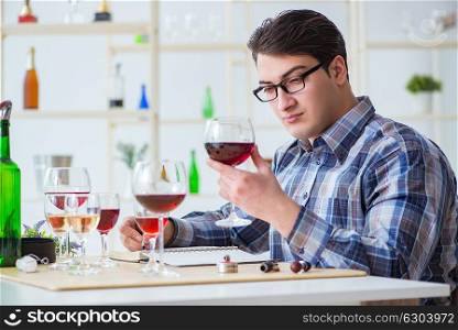 Professional sommelier tasting red wine