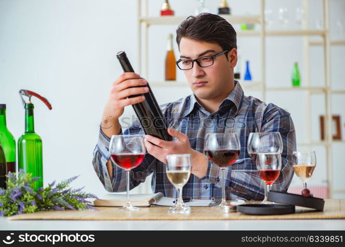 Professional sommelier tasting red wine