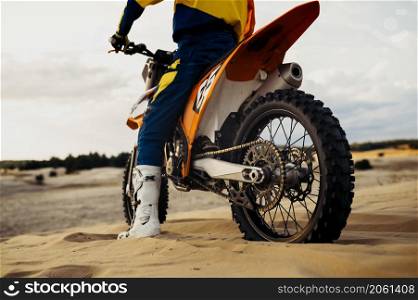 Professional speed rider driving in motocross race turns with slope. Extreme sport. Desert landscape. Professional speed rider driving in motocross race
