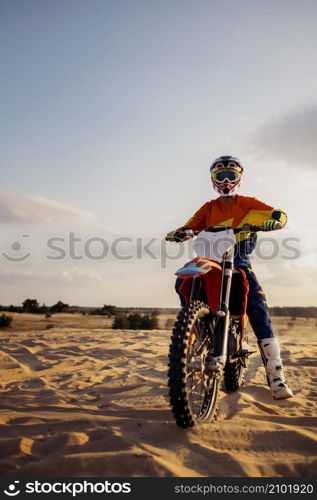 Professional speed rider driving in motocross race turns with slope. Extreme sport. Desert landscape. Professional speed rider driving in motocross race