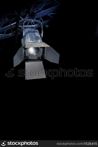 Professional stage spotlight lamp on black background. Professional stage spotlight