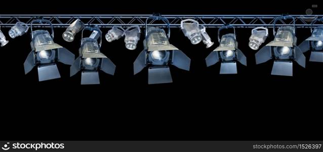 Professional stage spotlight lamps rack on black background. Stage spotlight rack