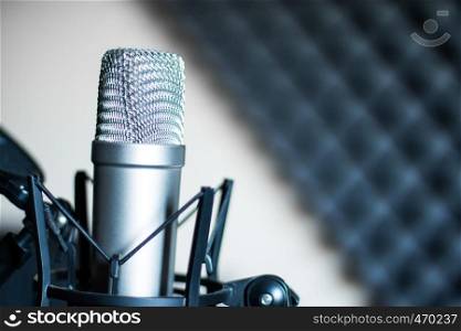 Professional studio microphone in a recording studio, sound insulation in the blurry background