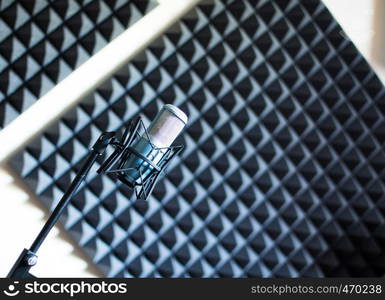 Professional studio microphone in a recording studio, sound insulation in the blurry background