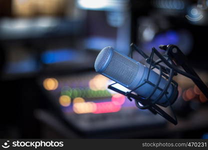 Professional studio microphone, recording studio, equipment in the blurry background