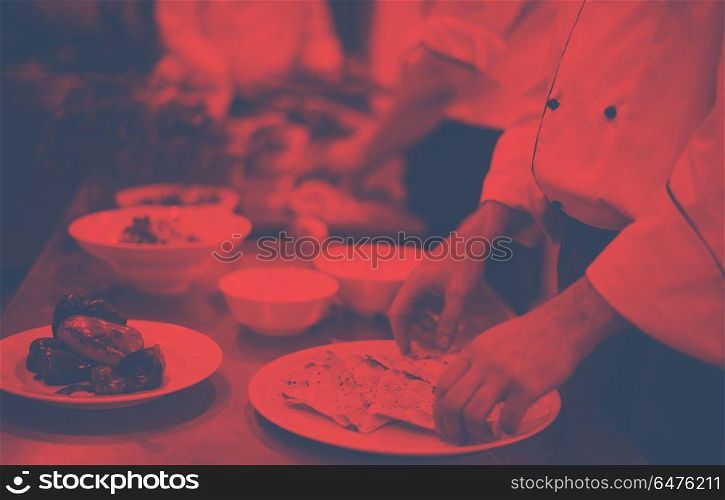 Professional team cooks and chefs preparing meal at busy hotel or restaurant kitchen. team cooks and chefs preparing meal