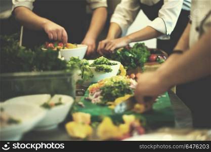 Professional team cooks and chefs preparing meals at busy hotel or restaurant kitchen. team cooks and chefs preparing meals