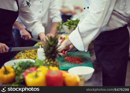 Professional team cooks and chefs preparing meals at busy hotel or restaurant kitchen. team cooks and chefs preparing meals