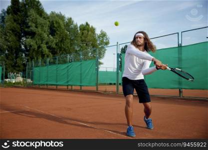 Professional tennis player with racket playing game on outside hard court. Outdoor sport activity. Professional tennis player playing game on outside hard court