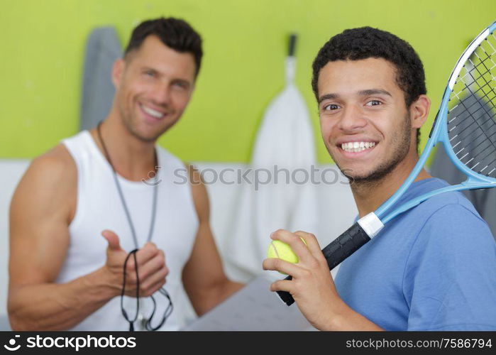 professional tennis trainer talking to tenis player