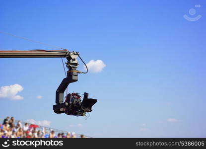 Professional TV camera on the crane on outdoor concerts