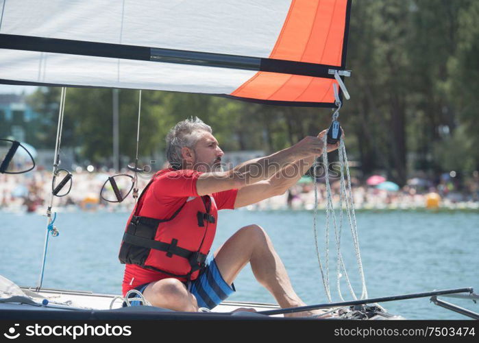 professional waterman training on lake with catamaran