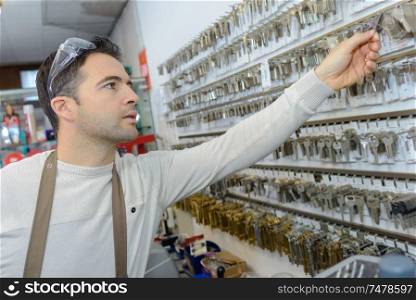 professional with different types of keys in locksmith