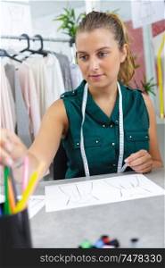 professional woman tailor designer drawing