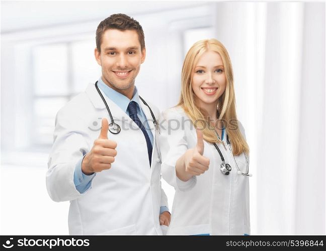 professional young team of two doctors showing thumbs up