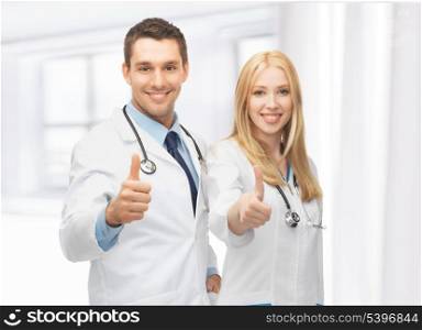 professional young team of two doctors showing thumbs up