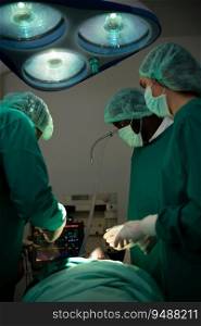 Professor of medicine in cardiology and a team of doctors in the operating room undergoing heart transplant surgery