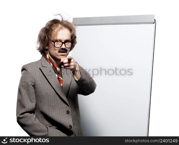 Professor / scientist / lecturer wearing horn rimmed glasses and fake mustache standing in front of a whiteboard and pointing into camera