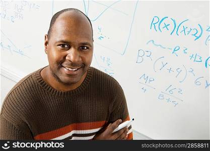 Professor Standing by Equations on Whiteboard