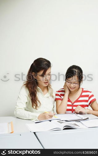 Professor teaching a student in the classroom