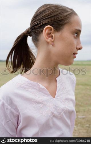 Profile of a girl in a field