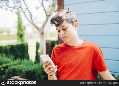 Profile of a happy guy texting on a smart phone