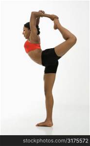 Profile of African American woman in Lord of the Dance Yoga position.