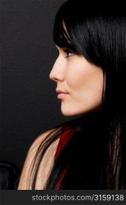 Profile of black haired woman in red top