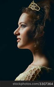 Profile of majestic young woman wearing tiara on black background