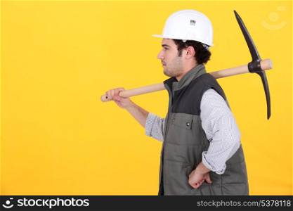 Profile of man with pick-axe